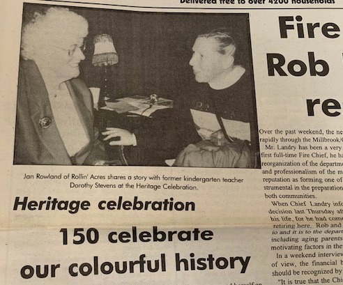 Two women converse in a newspaper photo at a heritage celebration; caption names Jan Rowland and Dorothy Stevens.